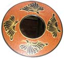 Tan color rounded fashion mirror with 4 black butterfly decor 