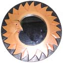 Black rounded mirror with tan color fire sun face design