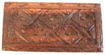 Long rectangular deep brown wooden box with carved pattern design on top 