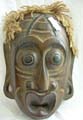 Black tribal man wooden mask with rope hair and large eyes and mouth