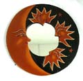 Rounded wooden mirror with tan sum moon star on black sky design
