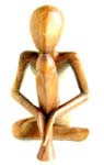 Yogi man in yoga sitting position cross one leg, holding both hand on shin and a head holding on knee