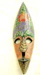 Nut shape face mask motif hibiscus on forehead with empty eye and dotted painting color design