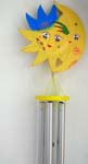 Yellow sun shine face disk holding 5 metal pipe wind chime, a yellow star with a blue hat suspending on bottom 