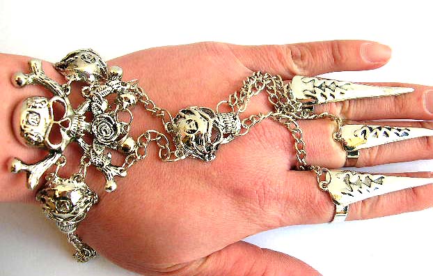 Fashion slave bracelet in double skull bones pattern design holding a jiggle bell end decor and 3 chain in sharp nail rings fashion       