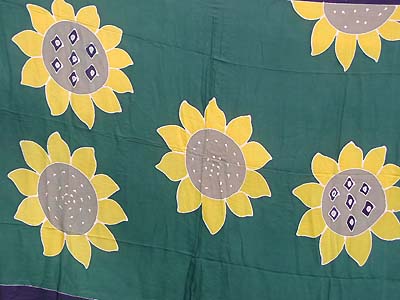 Floral motif batik sarong with sun flowers in green garden
