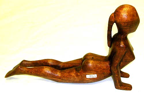 Native american craft - abstract carving of naked girl practicing yoga exercise