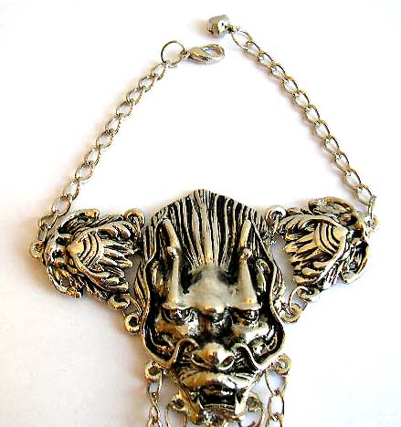 Fashion slave bracelet in double evil head pattern design holding a mini jiggle bell end decor and 3 chain in sharp nail rings fashion         